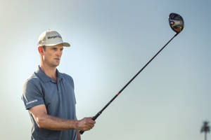 Justin Rose Looking At A Golf Club Wallpaper