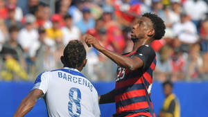 Kellyn Acosta Jumping Football Against Martinique Wallpaper