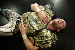 Kenny Omega Hugging His Championship Belts Wallpaper