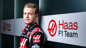 Kevin Magnussen Leaning Casually Against A Wall Wallpaper