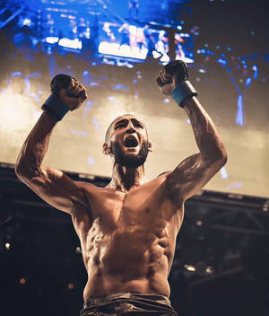 Khamzat Chimaev In Front Of Screen Wallpaper