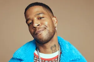 Kid Cudi Smilingin Blue Fur Coat Wallpaper