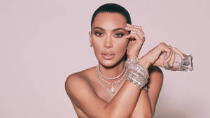 Kim Kardashian With Her Iconic Kkw Fragrance Wallpaper