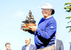 Kirk Triplett Holding A Trophy Wallpaper