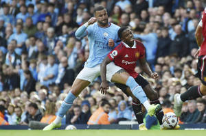 Kyle Walker In Action Against Tyrell Mings In A Tense Football Match. Wallpaper