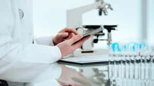 Laboratory Scientist Reading Tablet Wallpaper