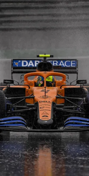 Lando Norris Racing Expertly Through The Rain Wallpaper