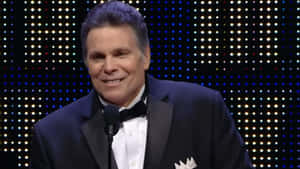 Lanny Poffo Smiling In Black Suit Wallpaper