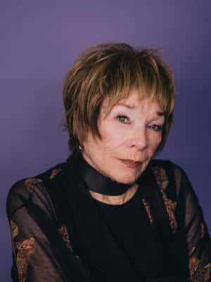 Legendary Actress Shirley Maclaine In Classic Black Dress Wallpaper