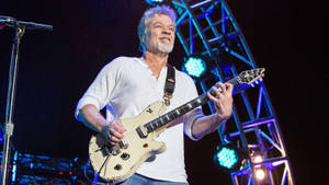 Legendary Guitarist Eddie Van Halen In Spotlight Wallpaper