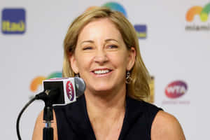 Legendary Tennis Player Chris Evert Speaking Into A Microphone Wallpaper