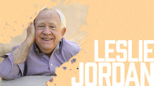 Leslie Jordan Exuding Charm Against A Yellow Background Wallpaper