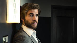 Liam Hemsworth Leaning On Wall Wallpaper