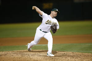 Liam Hendriks In His Dominant Pitching Stance Wallpaper