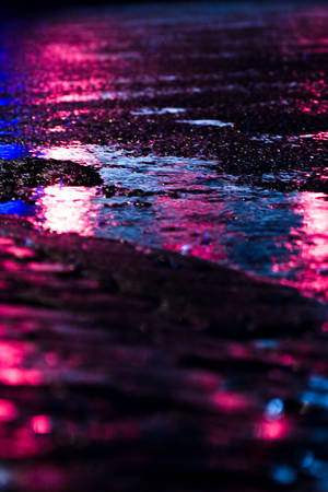 Light Purple Light Reflecting On Puddle Wallpaper