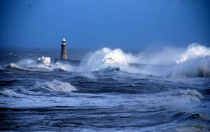 Lighthouse Amid Waves Wallpaper