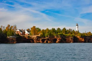 Lighthouse_on_ Cliffside_by_ Water Wallpaper