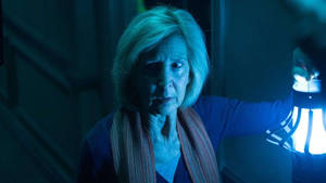 Lin Shaye In A Terrifying Movie Scene Wallpaper