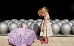 Little Girl Enjoying A Day Out In The Rain Wallpaper