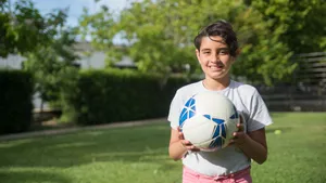 Little Girl Holding A Football Hd Wallpaper