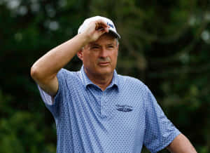 Loren Roberts Holding Golf Cap Wallpaper