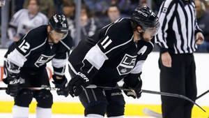 Los Angeles Kings' Players Anze Kopitar And Trevor Moore In Action Wallpaper