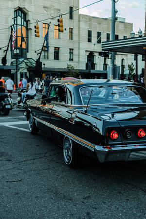 Lowrider Impala At Intersection Wallpaper