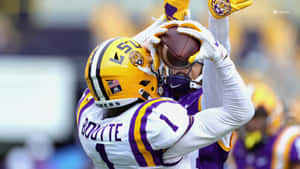 Lsu Football Hugging Ball Wallpaper