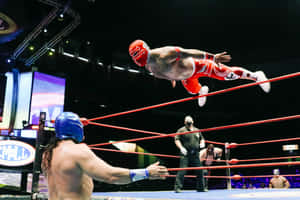 Luchador Mid Air Dive Wrestling Match Wallpaper