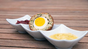 Luscious Scotch Egg British Dish With Mustard Sauce Wallpaper