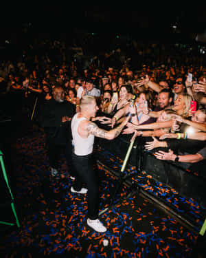 Macklemore Engagingwith Fans During Concert Wallpaper