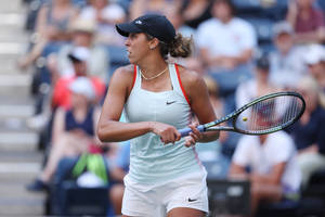 Madison Keys Displaying Athleticism In Tennis Attire Wallpaper