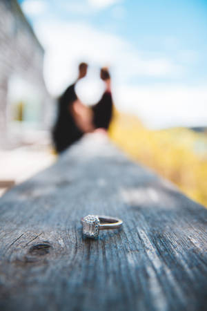 Magnificent Diamond Ring On A Wooden Surface Wallpaper