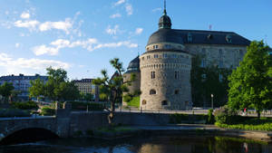 Magnificently Built Castle With A Beautiful Moat And Stone Bridge. Wallpaper