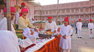 Maharaja Padmanabh Singh Admiring The Rich Heritage Of City Palace In Jaipur Wallpaper