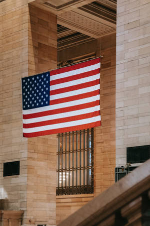 Majestic American Flag Waving Over Grand Central Station Wallpaper