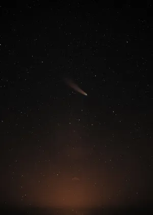 Majestic Comet Traversing The Night Sky Wallpaper