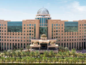 Majestic Dome Building Under Clear Blue Sky In Riyadh Wallpaper