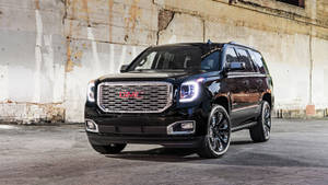 Majestic Gmc Vehicle In A Deserted Urban Area Wallpaper