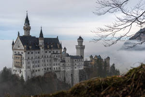 Majestic Neuschwanstein Castle Shrouded In Fog Wallpaper