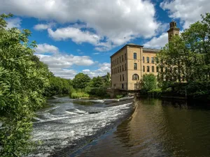 Majestic Salts Mill Against The Yorkshire Skyline Wallpaper