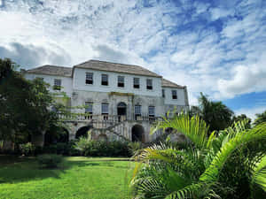 Majestic View Of Rose Hall Great House With A Dramatic Cloudscape Wallpaper