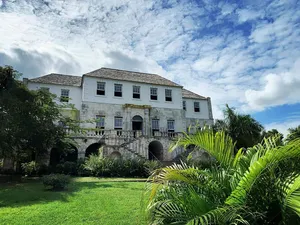 Majestic View Of Rose Hall Great House With A Dramatic Cloudscape Wallpaper