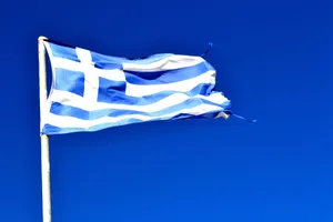 Majestic View Of The Greek Flag Against A Blue Sky Wallpaper