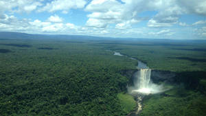 Majestic Waterfall In Dense Forest Wallpaper