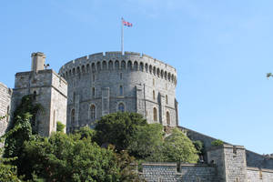 Majestic Windsor Castle With The Flag Of England Wallpaper