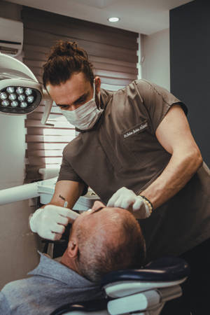 Male Dentist Checking Patient Dentistry Wallpaper