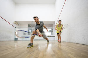 Man And Woman Team Playing Racquetball Wallpaper