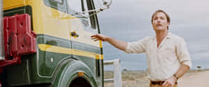 Man_by_ Truck_in_ Desert_ Scene Wallpaper