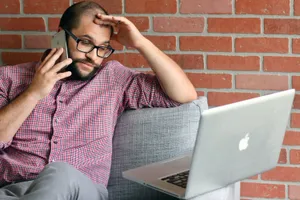 Man Expressing Frustration In A Working Environment Wallpaper